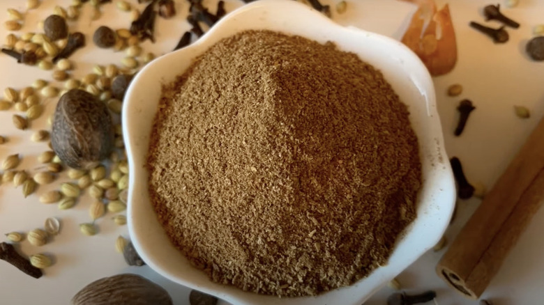 British mixed spice in bowl with cinnamon sticks