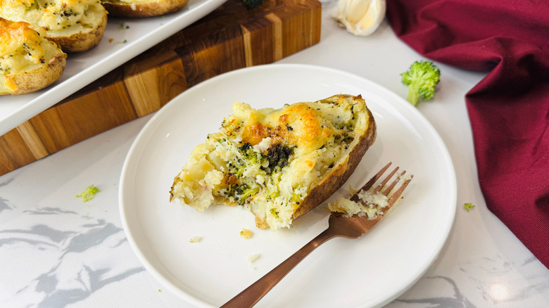 Broccoli cheddar twice baked potato on plate with fork