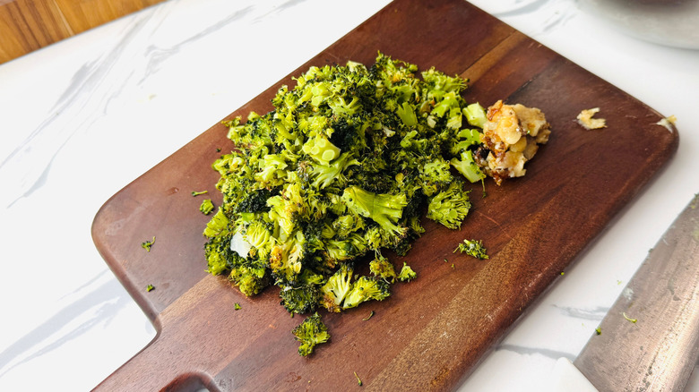 Chopped broccoli and garlic on wooden board