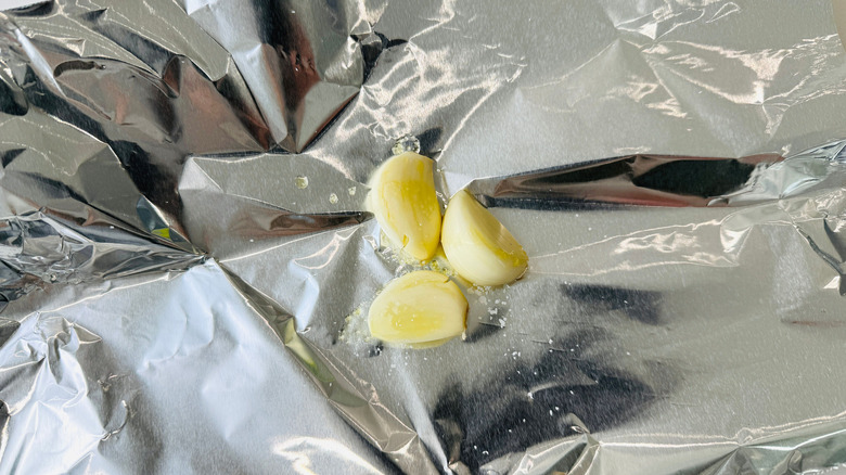 Garlic cloves on sheet of foil