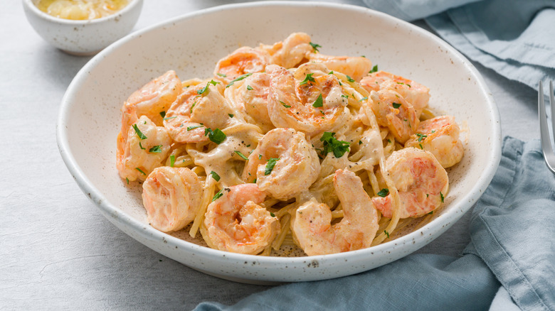 Creamy shrimp pasta in white bowl