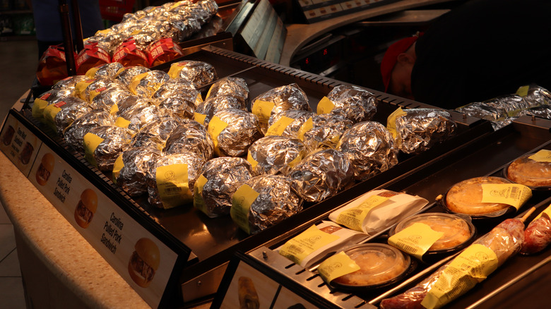 Burgers wrapped in tin foil sitting on the warming plate at Buc-ee's.