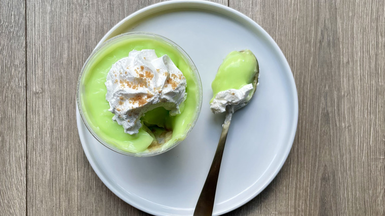 Key Lime pudding cup with a spoonful pulled out on a plate