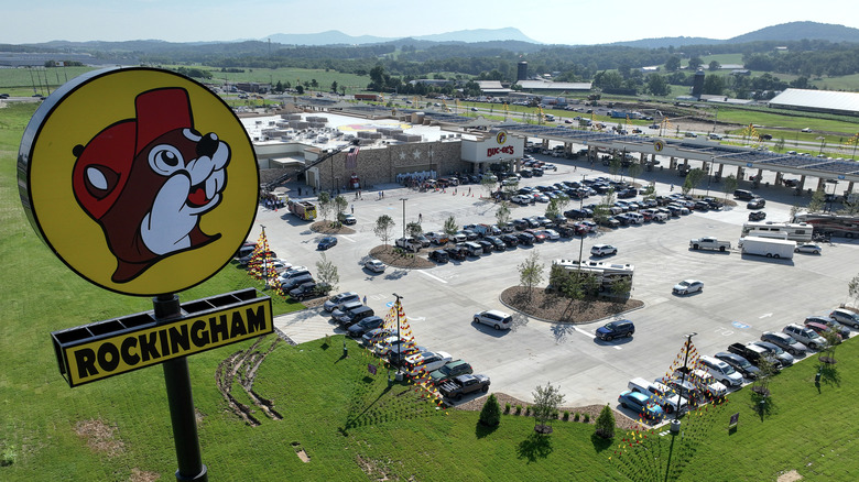 The iconic Buc-ee's sign high atop the travel center with mountains in the background