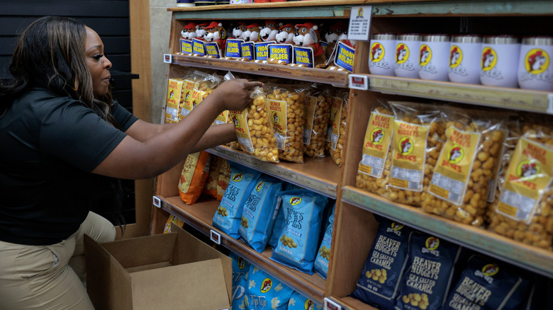 Employee at Buc-ee's stocking the shelves with a variety of beaver nuggets