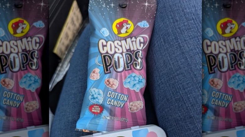 A package of Buc-ee's Cosmic Pops on a person's lap