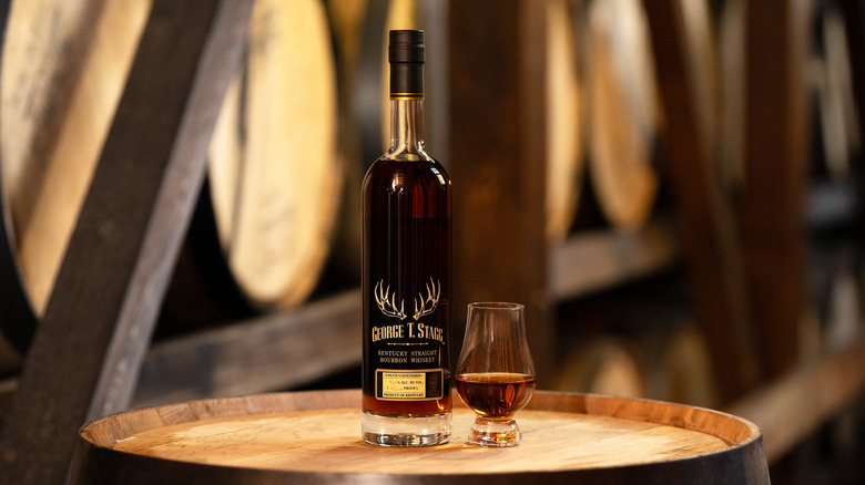 Buffalo Trace Antique Collection 2025, George T. Stagg bottle with glass in distillery