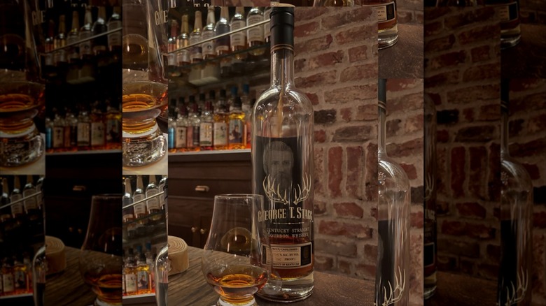 Empty bottle of Buffalo Trace George T. Stagg on bar, brick wall behind