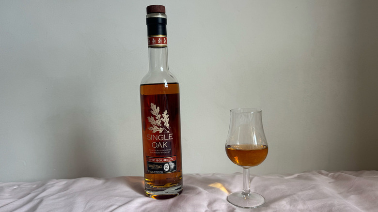 Buffalo Trace Single oak bottle with glass in front of white background