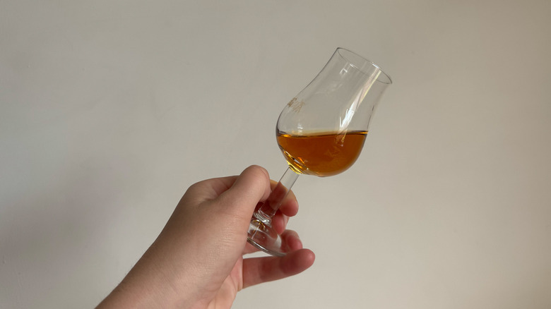 Buffalo Trace Single oak glass in hand, white background