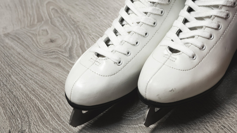 Figure skates on a gray floor