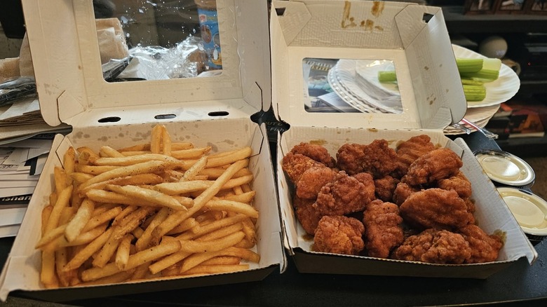 Buffalo Wild Wings boneless wings and fries in to-go containers
