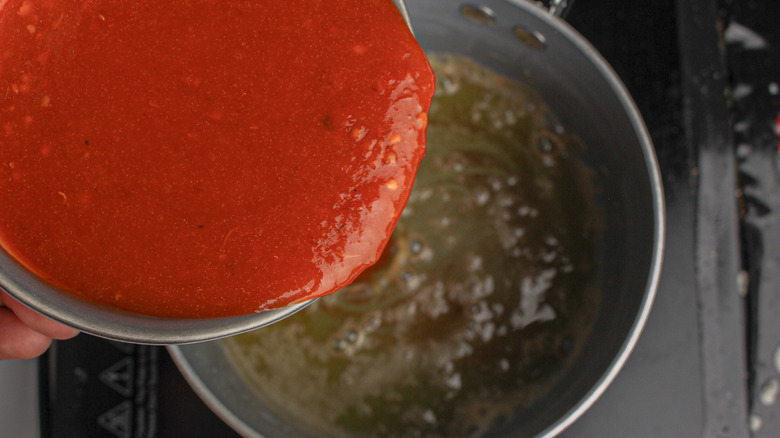 red sauce pouring into pan