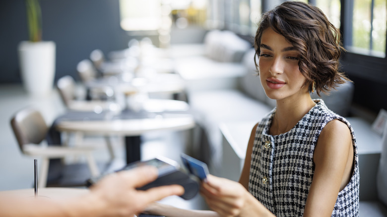 Woman paying with card at restaurant