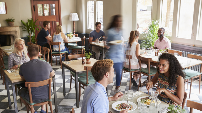 Customers enjoying meals at busy restaurant