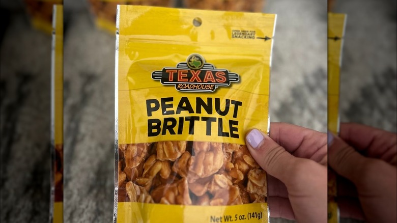 Small yellow package of Texas Roadhouse Peanut Brittle