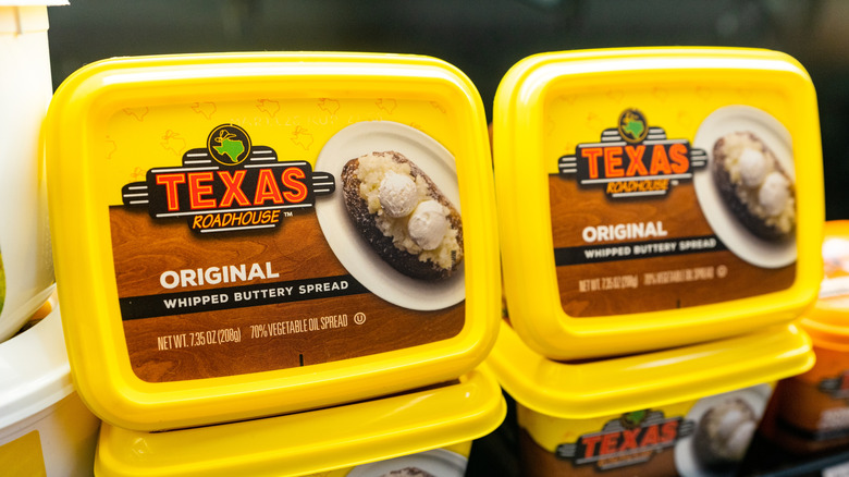 Yellow tubs of Texas Roadhouse Original whipped butter