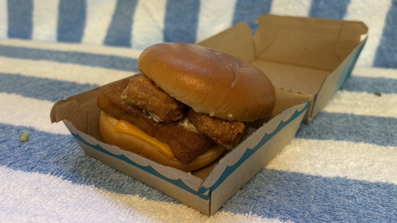 McDonald's Filet-O-Fish sandwich topped with chicken nuggets in its cardboard box