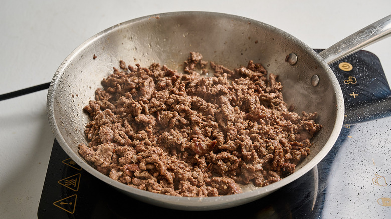 seasoning beef in a skillet