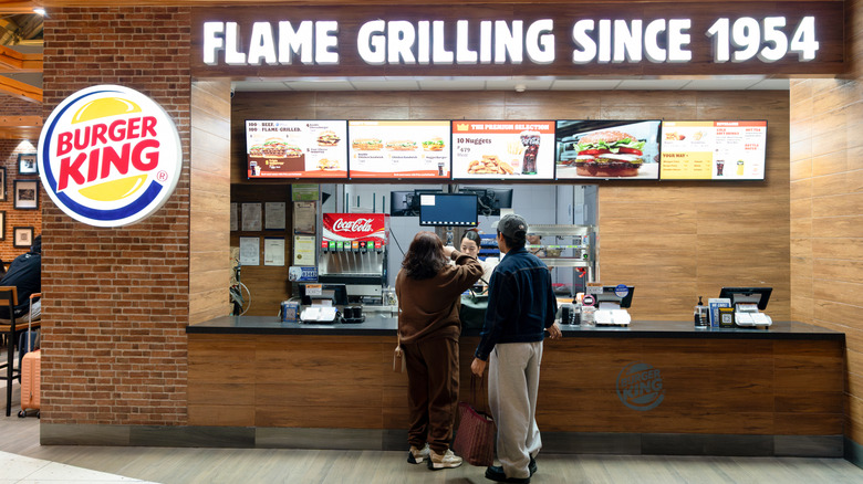 Two people ordering food at Burger King counter