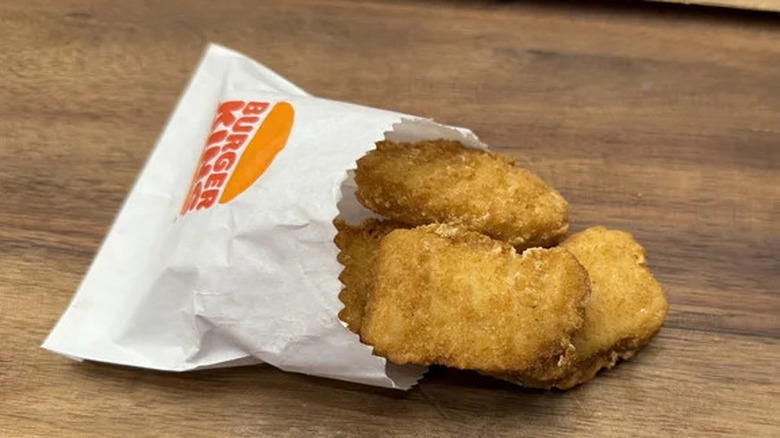 close up of Burger King's new nuggets in a paper bag on wood table