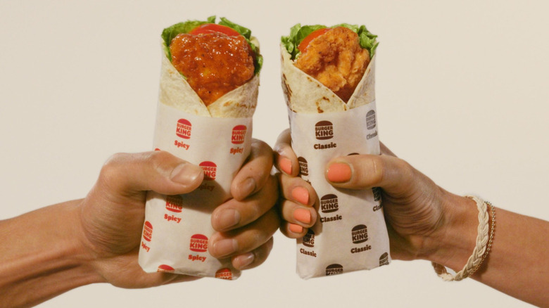 people holding crispy wraps from Burger King