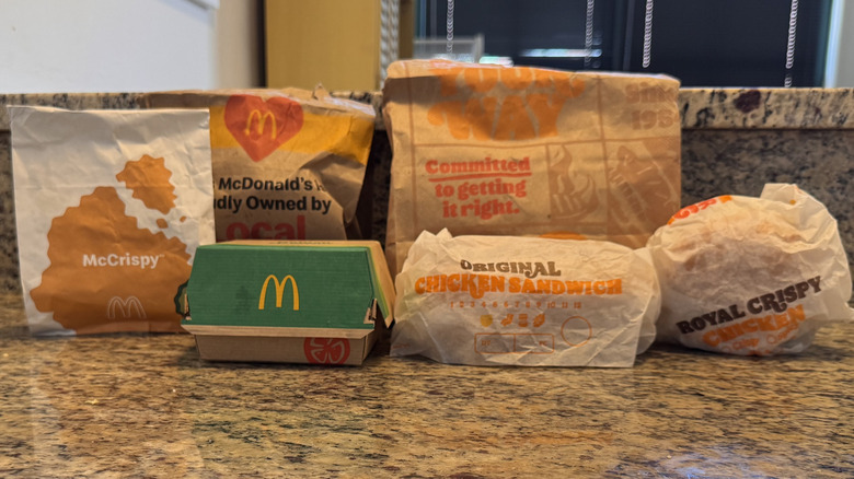 various chicken sandwiches from McDonald's and Burger King displayed on counter