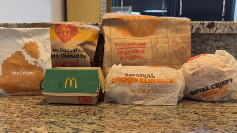 various chicken sandwiches from McDonald's and Burger King displayed on counter