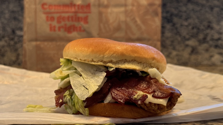 bacon and swiss royal crispy sandwich on opened wrapper on counter