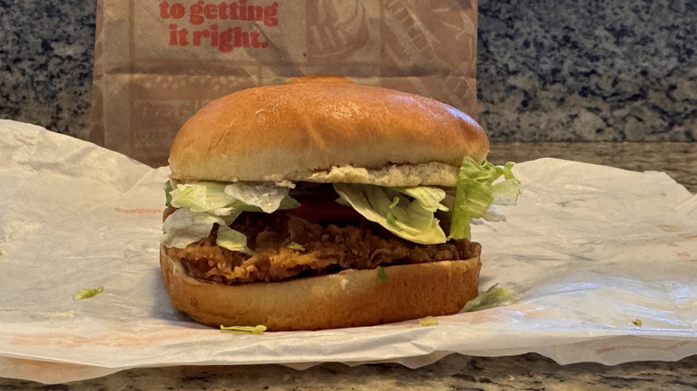 Royal chicken sandwich on opened wrapper on counter