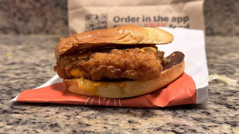 spicy McCrispy sandwich on opened wrapper on counter