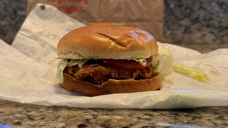 spicy royal sandwich on opened wrapper on counter