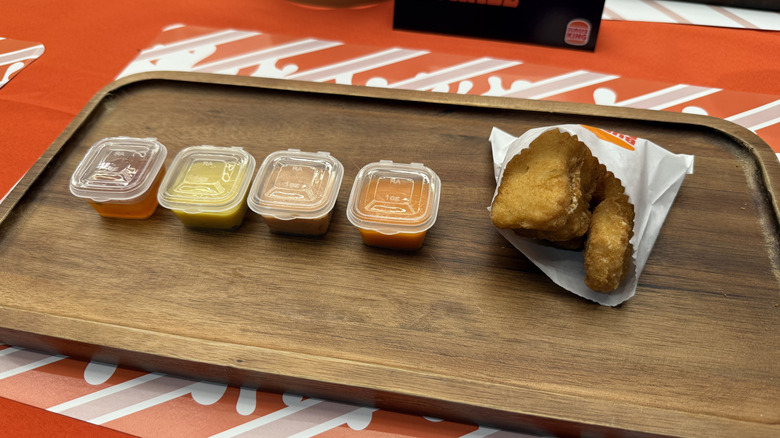 dipping sauces and a bag of nuggets in a row