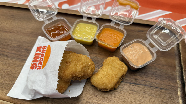 new Chicken Nuggets in front of four dipping suaces