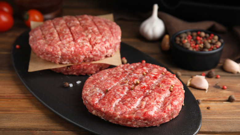 hamburger patties on black plate