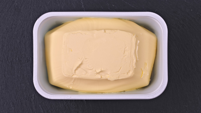 Block of margarine in container