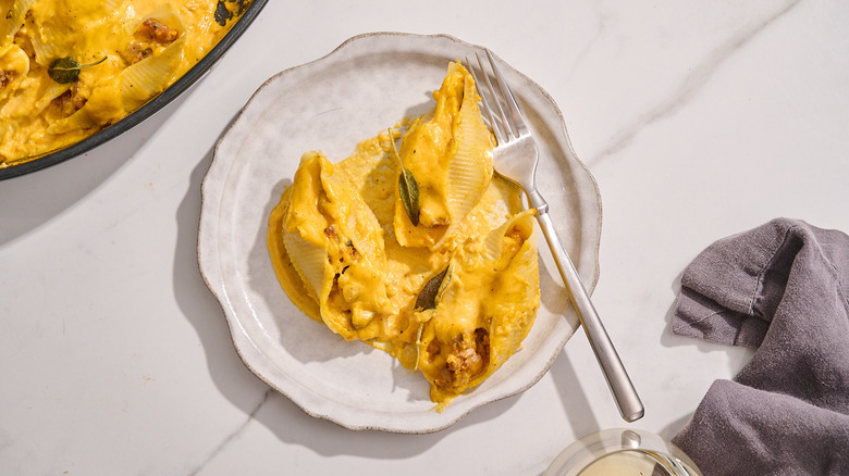 stuffed shells on a plate with a fork