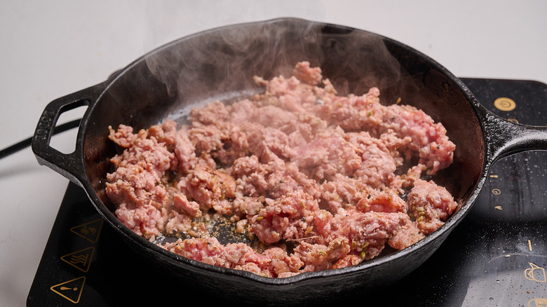crumbling sausage in a skillet
