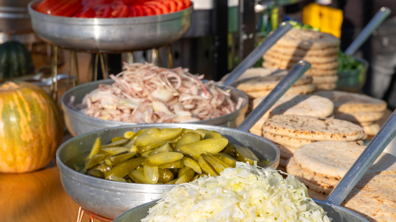 selection of sandwich toppings including pickles sauerkraut and obions