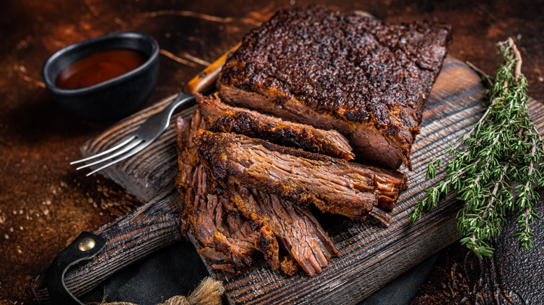 sliced smoked brisket on cutting board