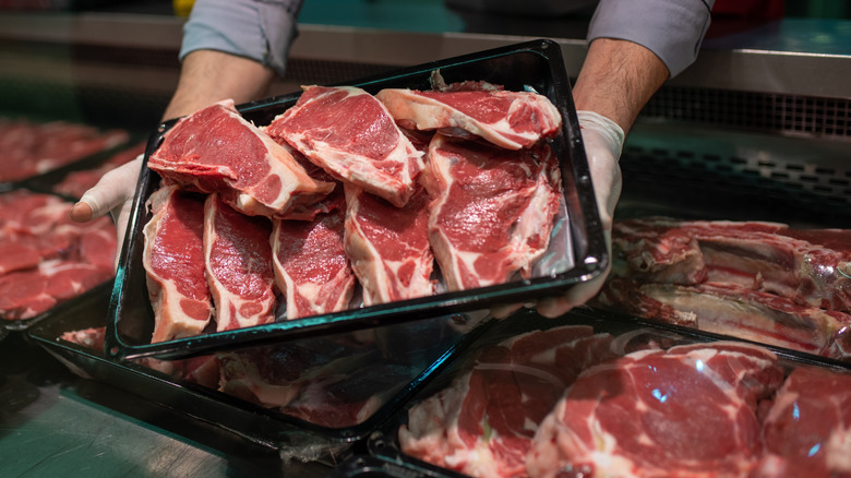 tray full of raw steaks