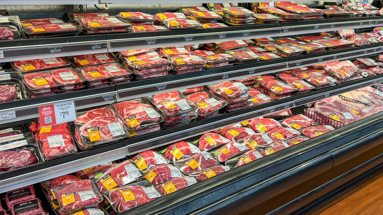 wide range view of refrigerated meat section in supermarket