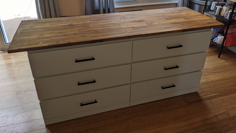 DIY kitchen island constructed from a dresser with wooden countertop