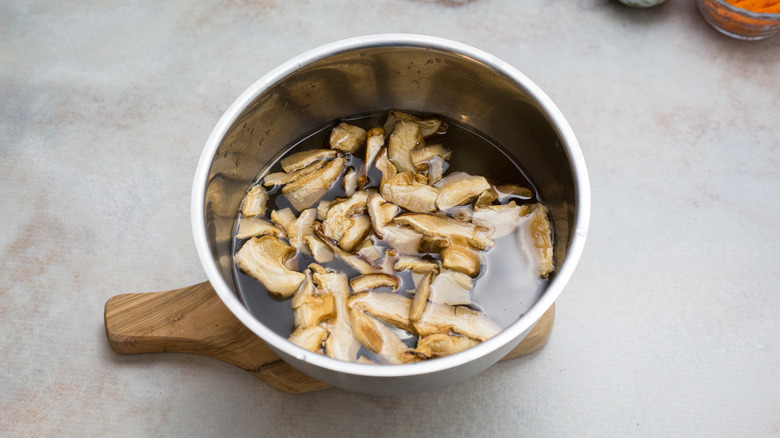 mushrooms soaking in metal bowl