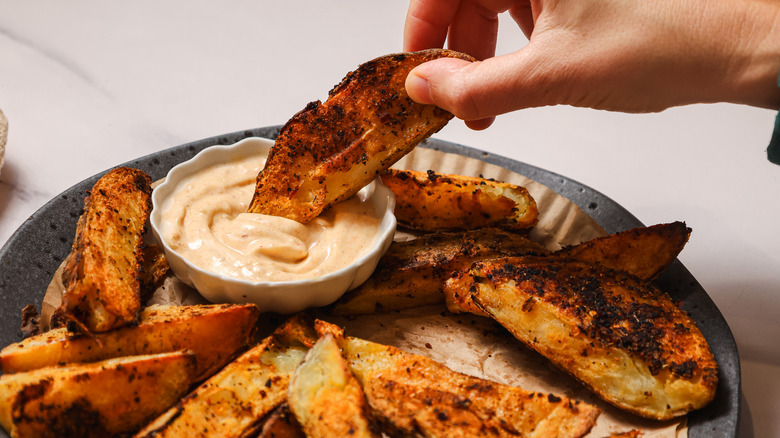 Dipping steak fries into aioli