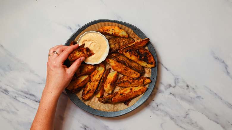 Dipping steak fries into aioli