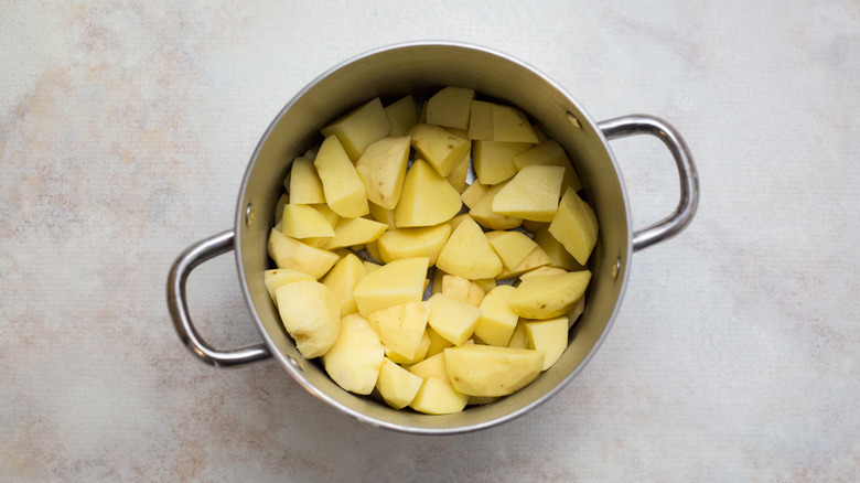cut potatoes in medium pot