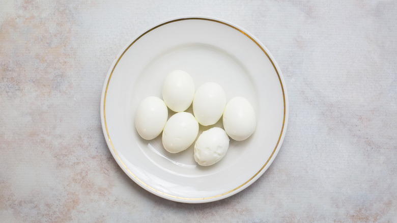 peeled hard-boiled eggs on plate