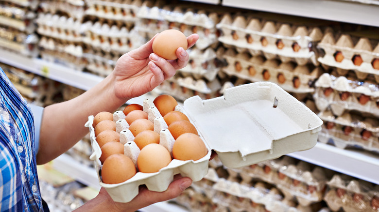 Grocery shopper looking at eggs