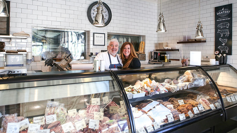 Todd and Ada Fisher of The Meatery smile behind the case at the store